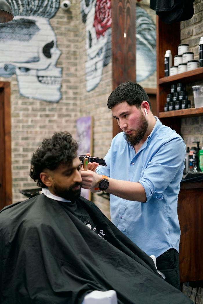 Skullfade barber trimming a client's beard at the Financial District shop